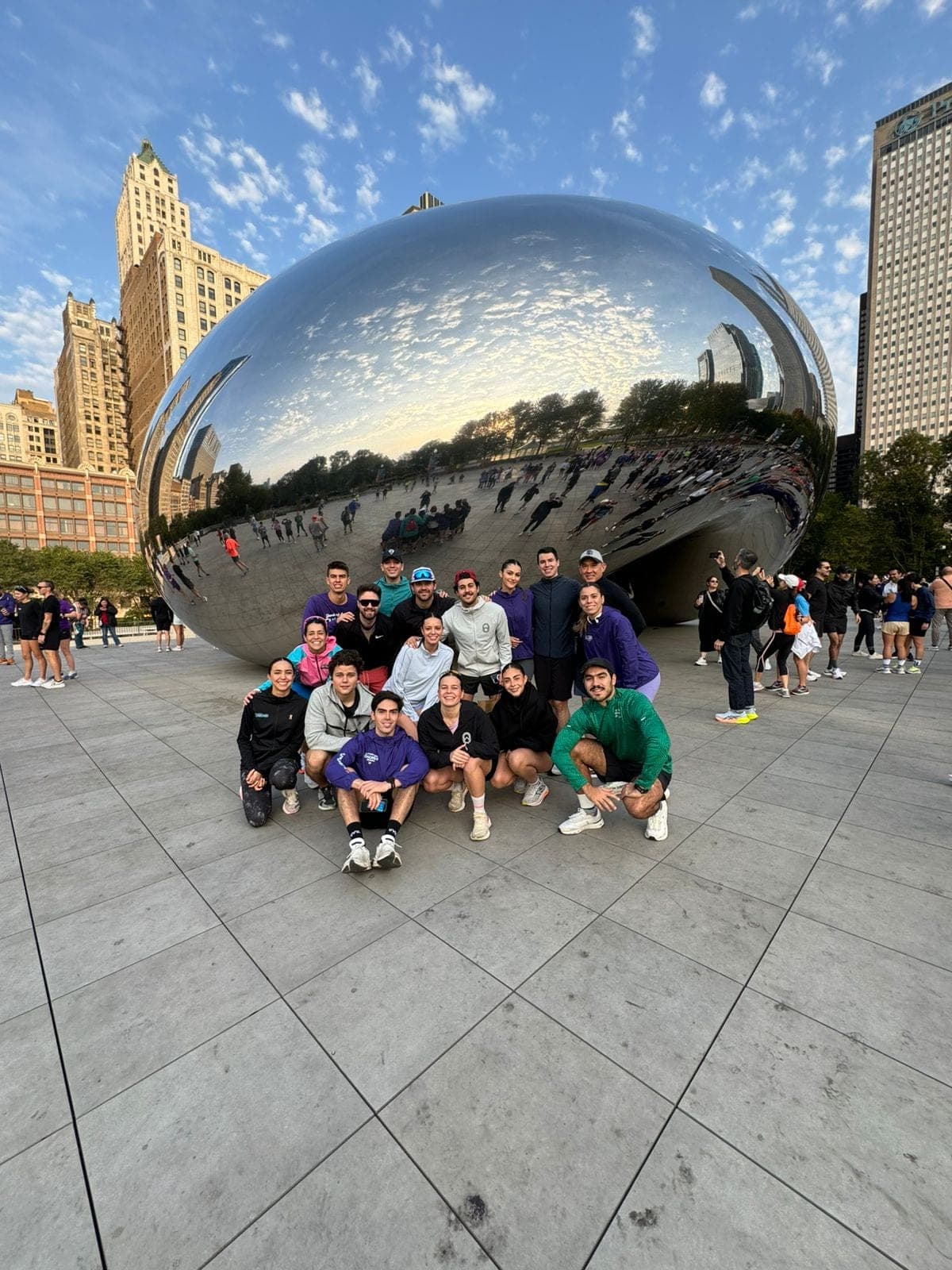 Wave One group posing in front of the Chicago Bean under a clear blue sky