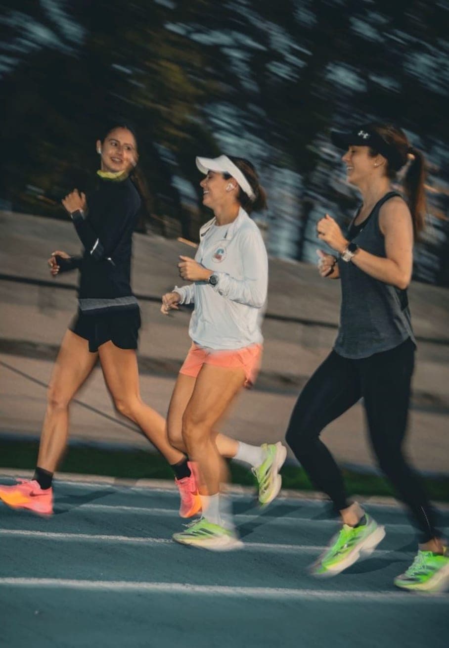 Three Wavers floating through a dawn track interval together, motion-blurred trees behind them