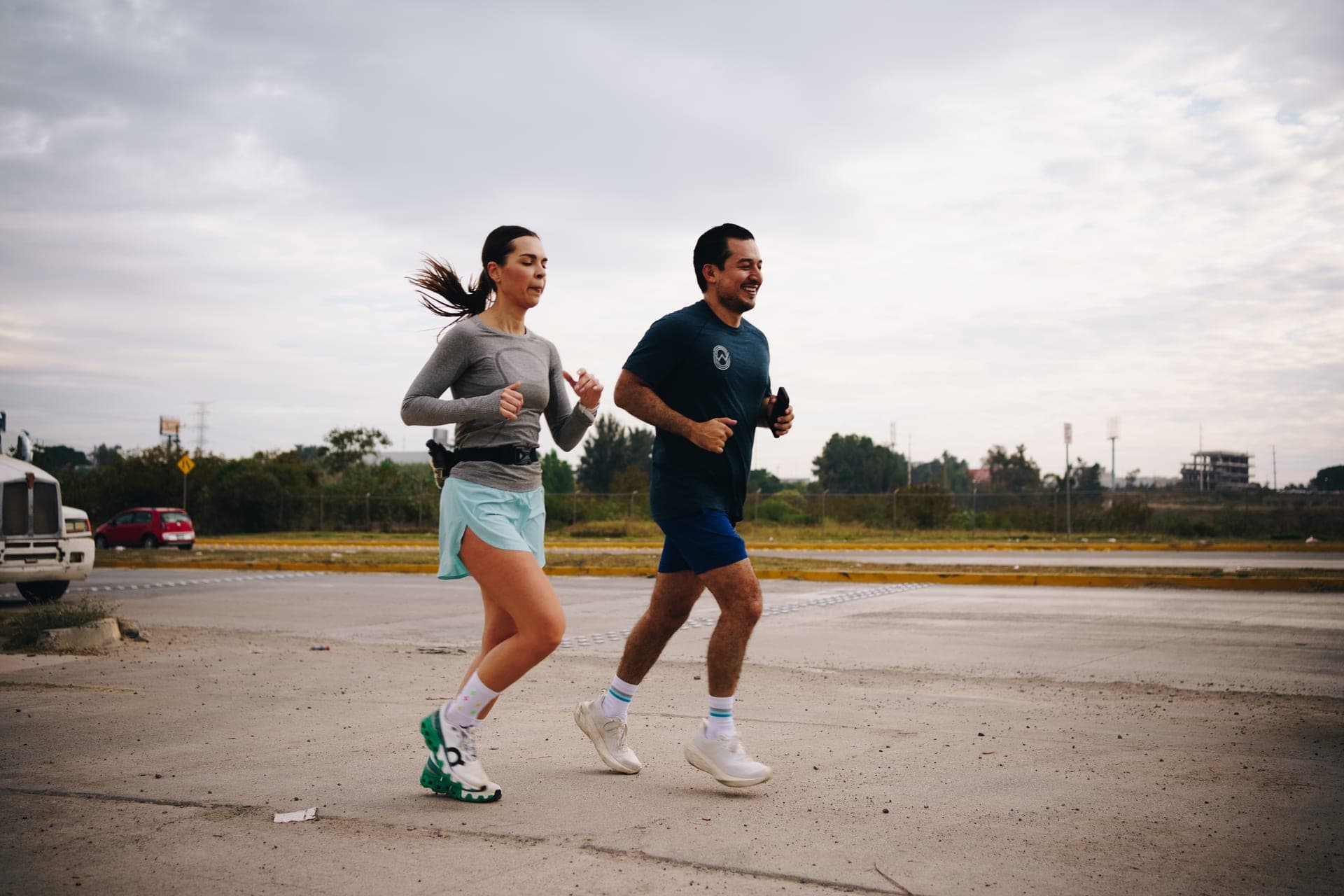 Two Wavers easing through a Saturday long run on an empty parking lot under a grey morning sky